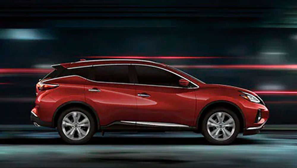 2023 Nissan Murano shown in profile driving down a street at night illustrating performance. | South Colorado Springs Nissan in Colorado Springs CO